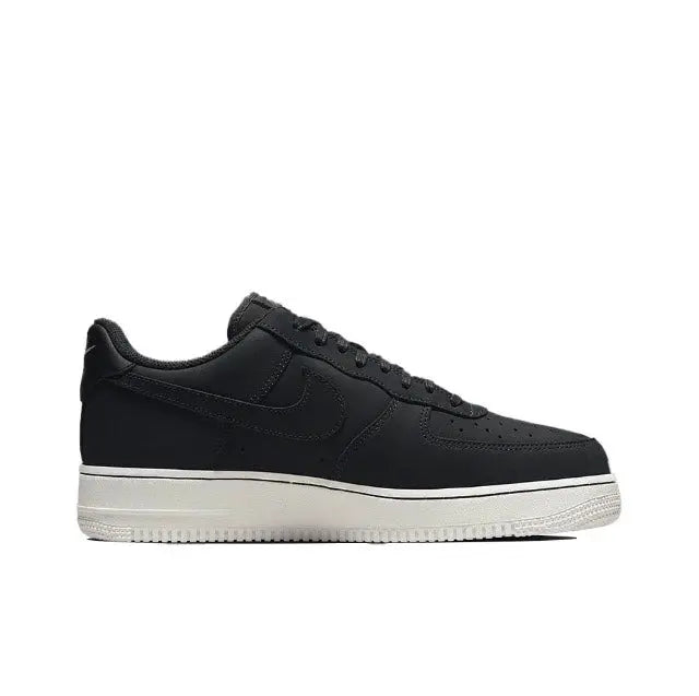 Nike low-top sneaker side view in dark leather with swoosh and white midsole