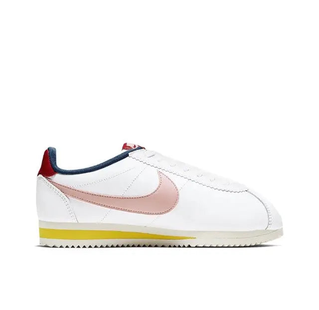 Nike Cortez sneakers side profile, white leather, pink swoosh, navy collar, yellow outsole