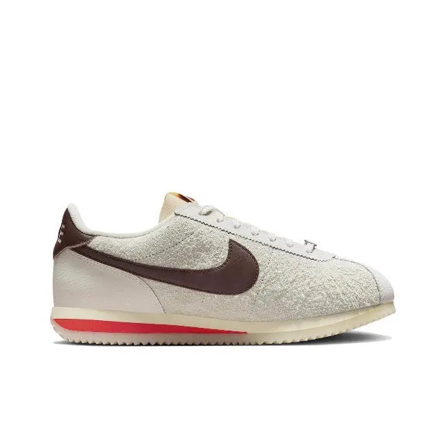 Nike Cortez low-top sneakers side view, beige upper with dark maroon swoosh and gum sole
