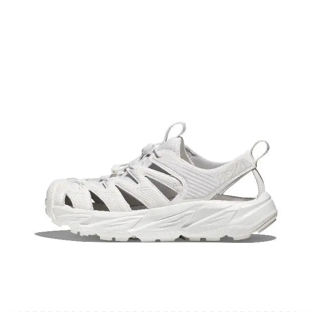 White lace-up trail sneaker with open mesh-like panels, padded tongue, and tread sole