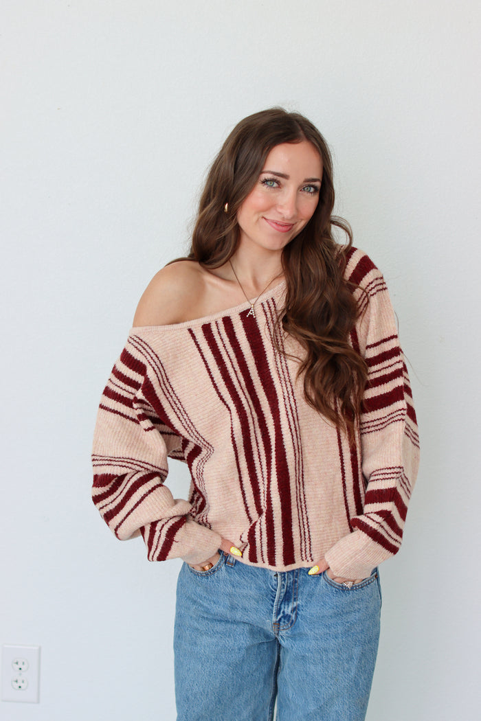 Woman wearing a dark red striped off the shoulder top