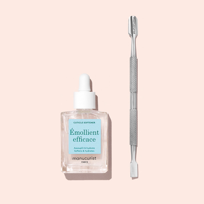 A box of 20 Manucurist Wooden cuticle sticks rests on a light pink background—essential tools for perfectly prepped nails.