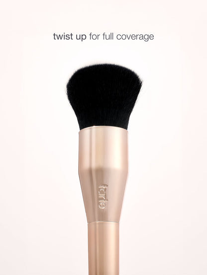 Makeup brush with black bristle head and rose gold handle on a white background