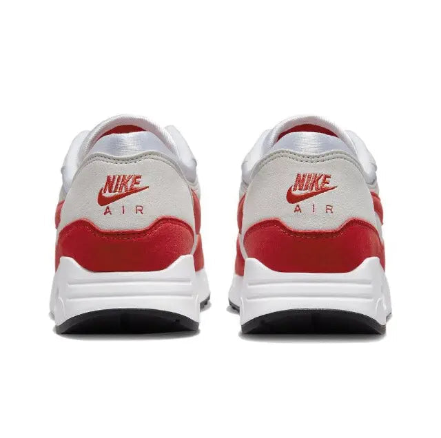 Back view sneakers with red heel panel and Nike Air logo on white upper