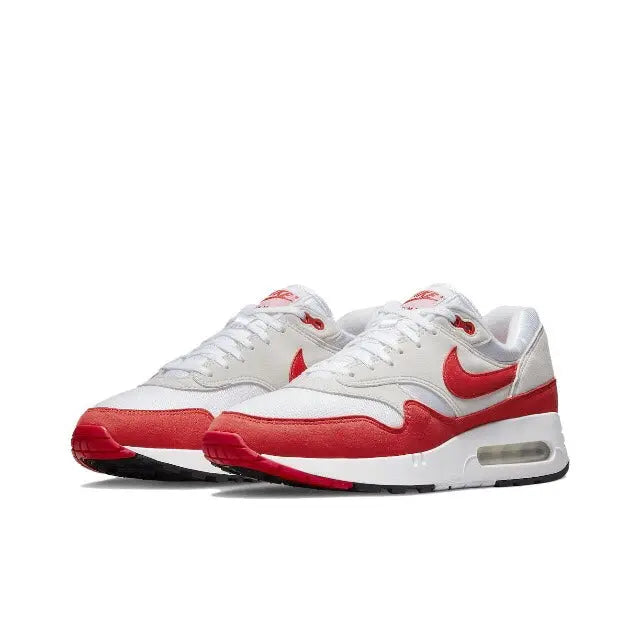 White low-top sneakers with red swooshes, Air Max window, and lace-up front