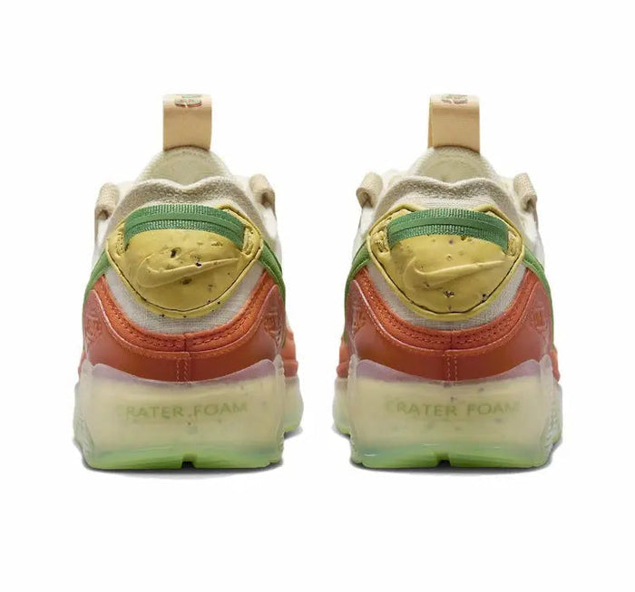 Air Max 90 sneakers heel with green trim, orange pull tab, translucent outsole