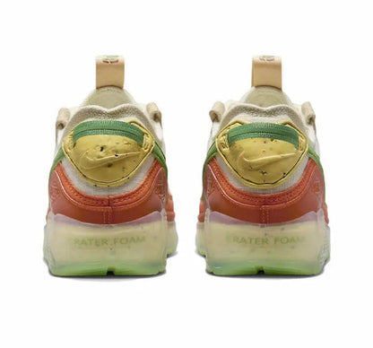 Air Max 90 sneakers heel with green trim, orange pull tab, translucent outsole