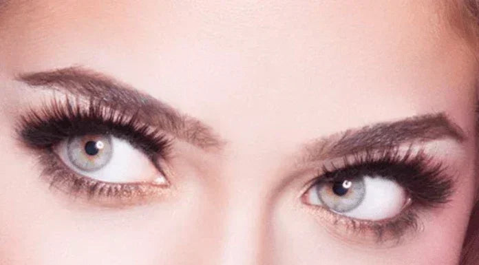 Model with dramatic black strip false eyelashes and natural volume look