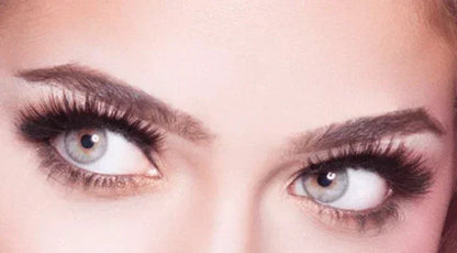 Model with dramatic black strip false eyelashes and natural volume look