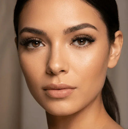 Woman wearing black strip false eyelashes, full volume, natural makeup look