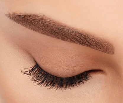 Close-up of closed eye with natural-looking, light volume, short length false eyelashes applied