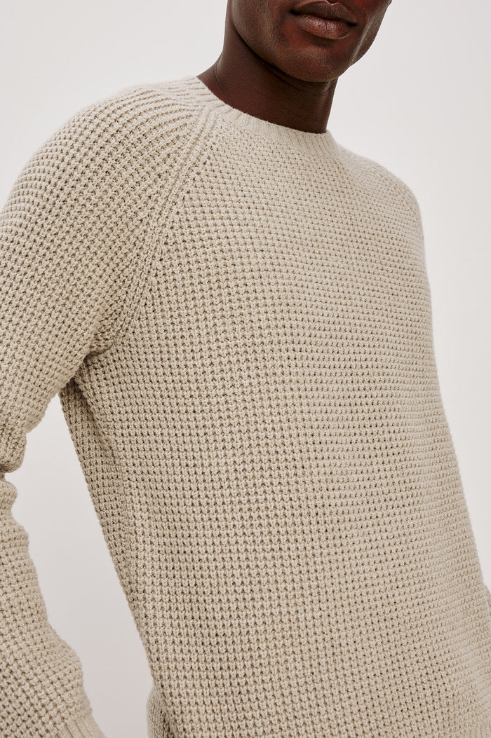 Augustus Sweater in Midweight Cotton-Linen Knit With Thermal Stitch, Textured Bouclé Finish, Raglan Long Sleeves, and Ribbed Trim in Vellum Colorway - Upper Body Close Up View Featured on Model