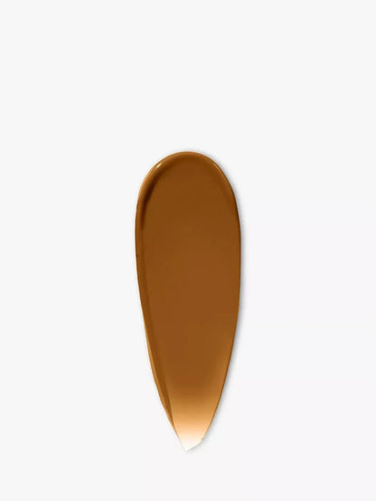 Deep brown tinted moisturizer cream swatch on a white background, SPF face makeup