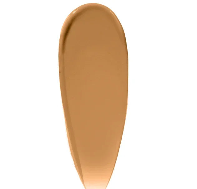 Beige cream swatch of skin tint makeup with SPF on a white background
