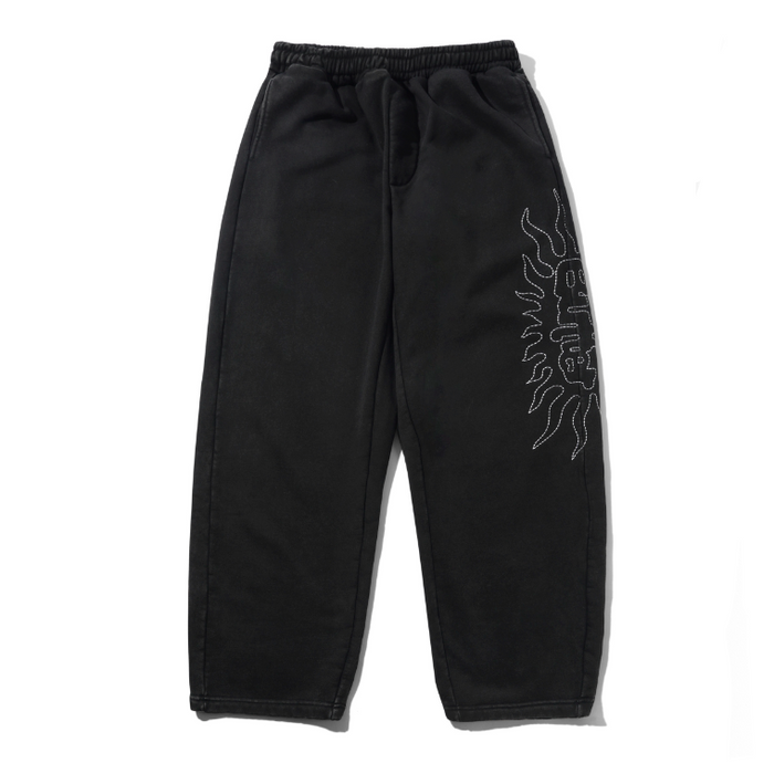 Black sweatpants with a white flame graphic and 'BREATHE' text on the left leg, displayed next to a light gray version of the same pants on a white background.