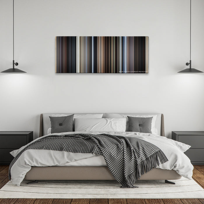 Cast Away color palette canvas above a bed, between two black pendant lamps