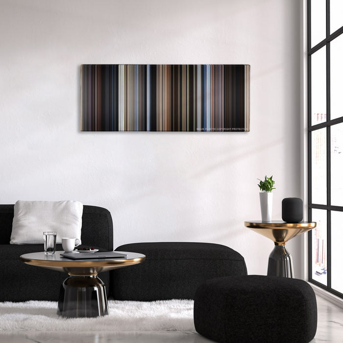 Cast Away color palette canvas above a black sofa with a gold-topped table