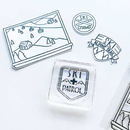 Catherine Pooler - Stamp & Dies - Ski Lodge. The Ski Lodge Stamp Set gives you a view of the mountain along with badges and sentiments for adorable snowy card making! You can also add Alpine View Die for your wintery mix (Sold Separately). Available at Embellish Away located in Bowmanville Ontario Canada.