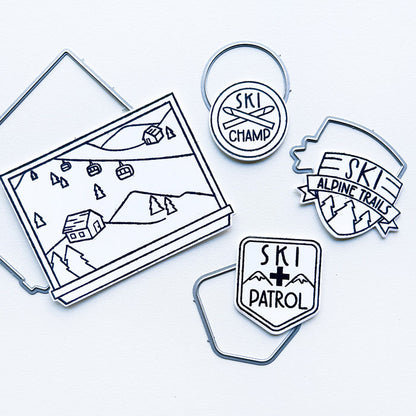 Catherine Pooler - Stamp & Dies - Ski Lodge. The Ski Lodge Stamp Set gives you a view of the mountain along with badges and sentiments for adorable snowy card making! You can also add Alpine View Die for your wintery mix (Sold Separately). Available at Embellish Away located in Bowmanville Ontario Canada.
