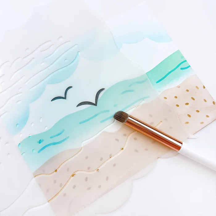 Catherine Pooler - Stencil - Sand & Sea. This smart stencil has four sides cut to use for blending clouds, waves, and the sandy beach edge. Add texture to the water and sand with the inside elements of the stencil. Add pair of seagulls in the distance. Available at Embellish Away located in Bowmanville Ontario Canada.