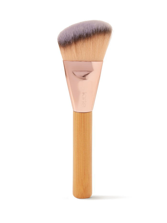 Makeup brush with wooden handle and gray bristles on a white background