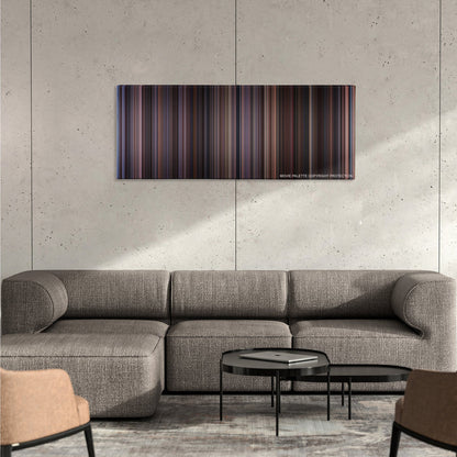 Chocolat color palette canvas on a concrete wall above a gray sectional sofa