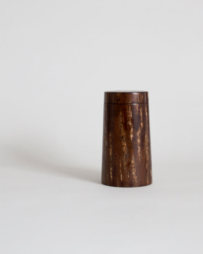 Wooden cylindrical coffee container by Denshiro on a gray background