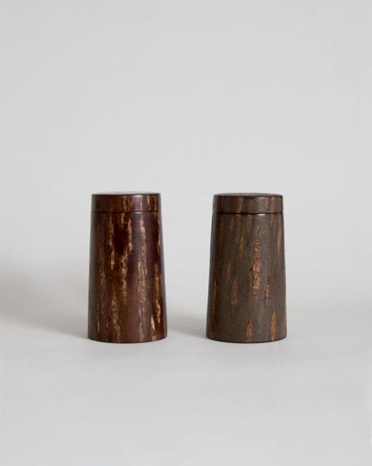 Wooden cylindrical coffee container by Denshiro on a light gray background