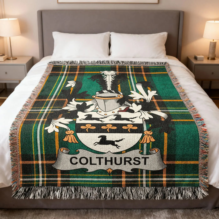 Colthurst family crest woven blanket draped across a bed.