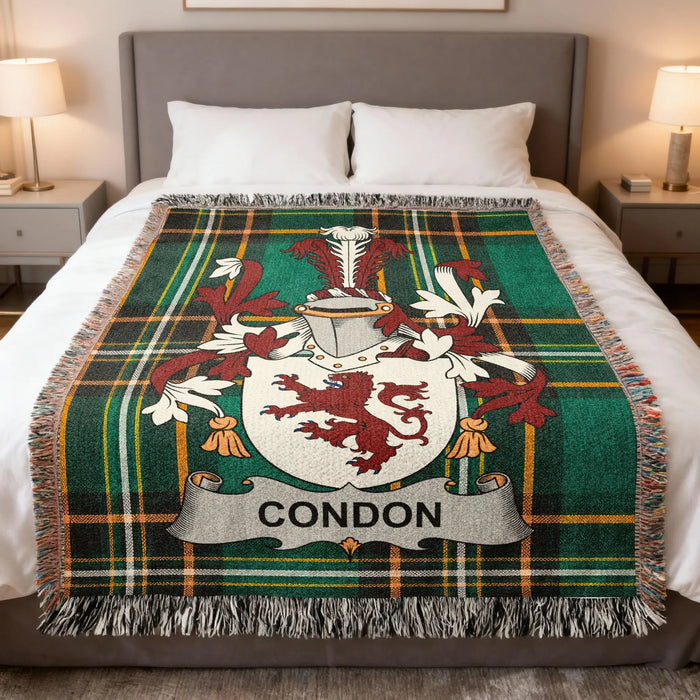 Condon family crest woven blanket laid across a bed.