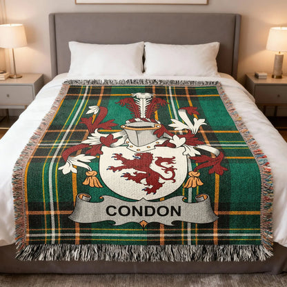 Condon family crest woven blanket laid across a bed.