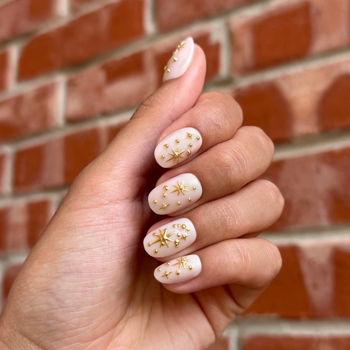 Confetti Sparkle - Press-On | Short | Round nails with milky base and gold star and dot embellishments for easy at-home manicure