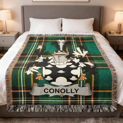Conolly family crest woven blanket laid over a bed.
