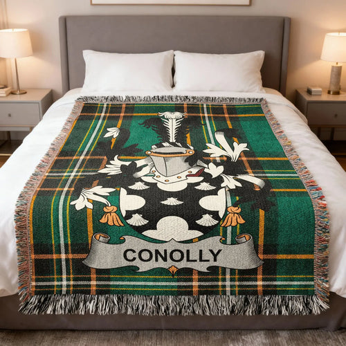 Conolly family crest woven blanket laid over a bed.