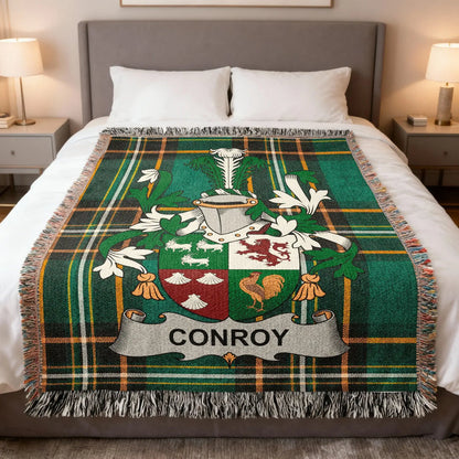 Conroy family crest woven blanket spread across a bed.