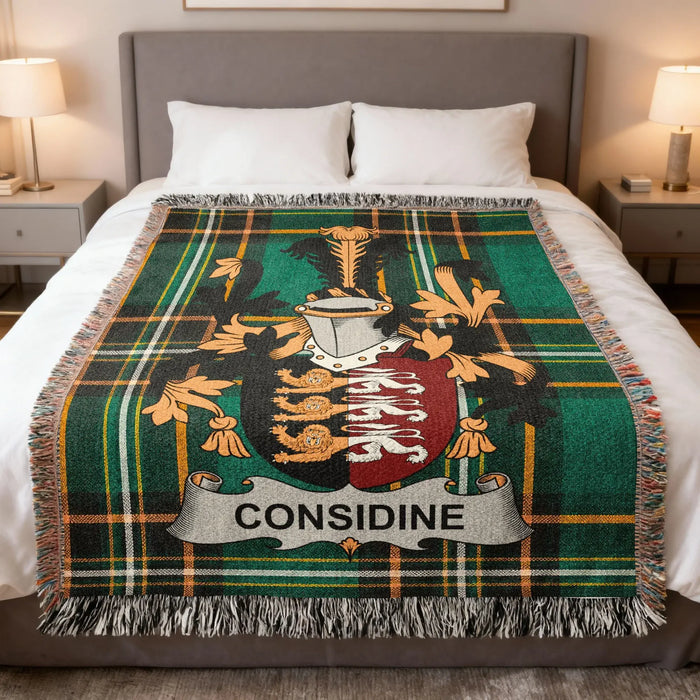 Considine family crest woven blanket folded over a bed.