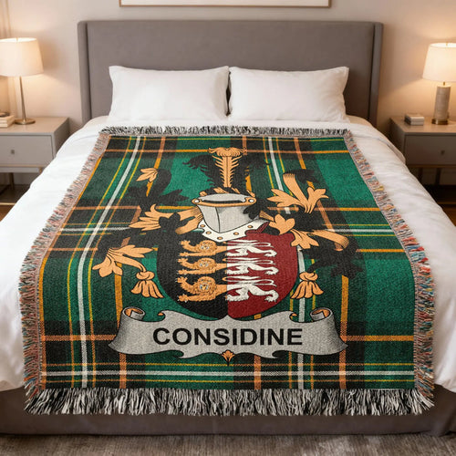 Considine family crest woven blanket folded over a bed.