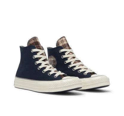 Pair of navy Converse high-top sneakers with plaid lining and white rubber sole