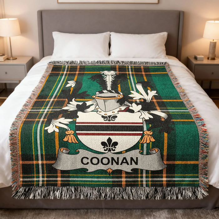 Coonan family crest woven blanket laid across a bed.