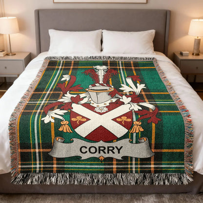 Corry family crest woven blanket spread over a bed.