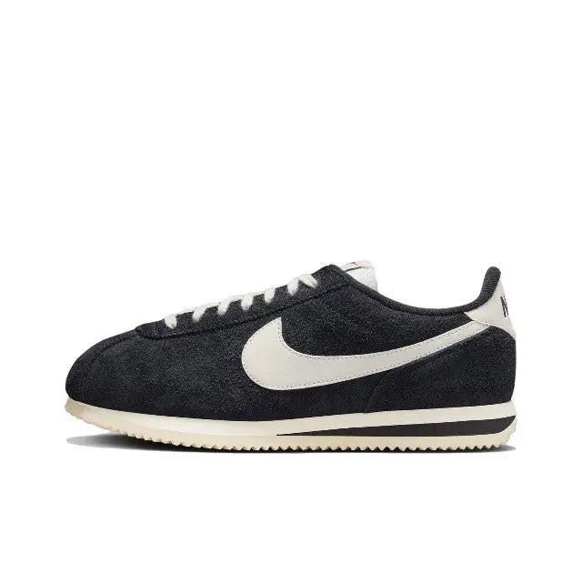 Nike Cortez sneakers, black suede with white swoosh and striped midsole
