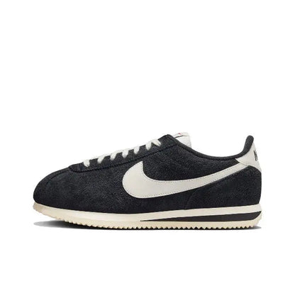 Nike Cortez sneakers, black suede with white swoosh and striped midsole