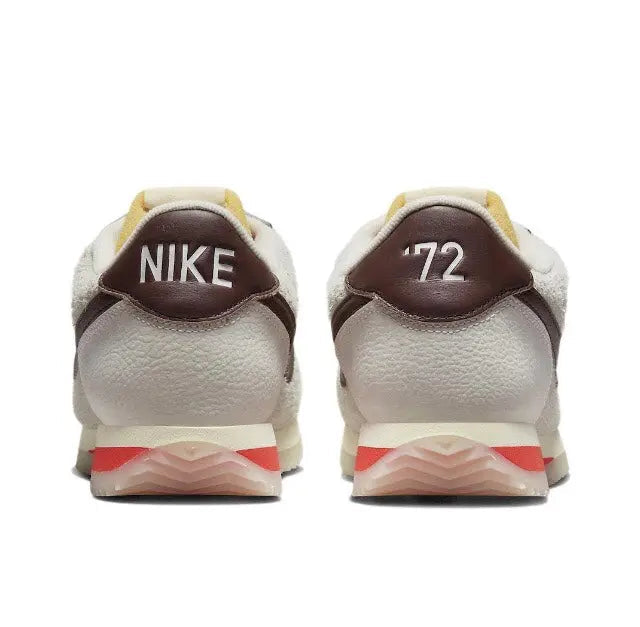 Nike Cortez sneakers with maroon heel panels, “NIKE” on back, and red midsole stripe