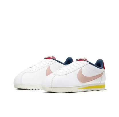 Nike Cortez low-top sneakers pair, white uppers with pink swooshes, navy lace loops