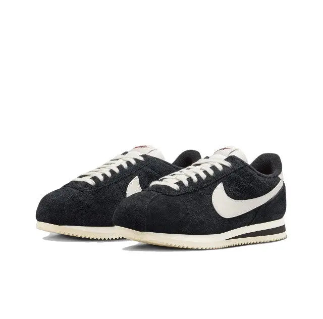 Cortez sneakers pair, black suede with white swoosh and cream outsole