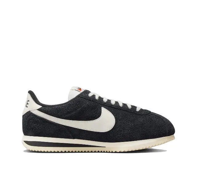 Cortez sneakers side profile, black suede with white swoosh and cream sole