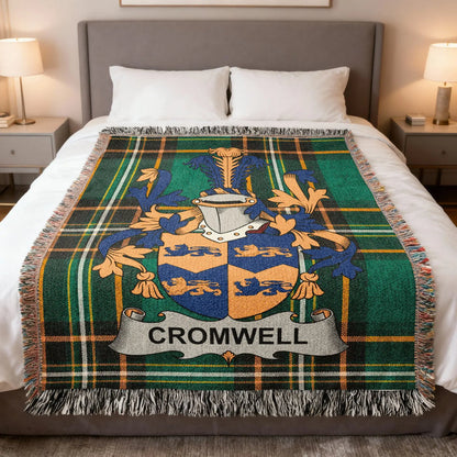 Cromwell family crest woven blanket spread on a bed.