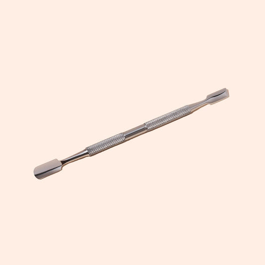 The Manucurist Cuticle Pusher, made of stainless steel with a textured grip and dual flat, rounded tips, is shown on a light beige background—an essential tool for precise nail care.
