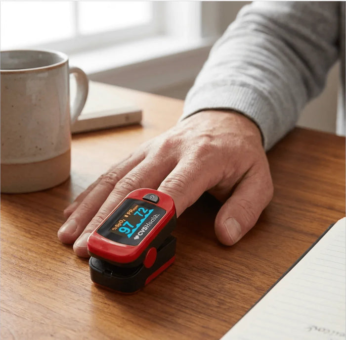 Portable pulse oximeter on finger measuring oxygen level and heart rate on wooden table
