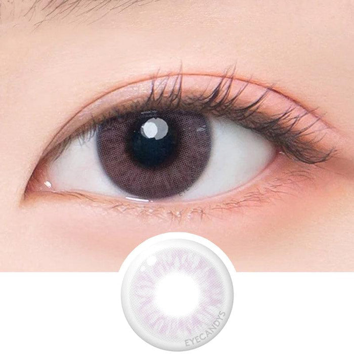 Macro shot of an eye wearing the DooNoon Bono Pink prescription colour contact lens, showing the multi-colored detail and natural effect on dark brown eyes, with clean eye makeup. At the bottom is the pattern of the colored lens design, showing the dotted detail and pigmentation.